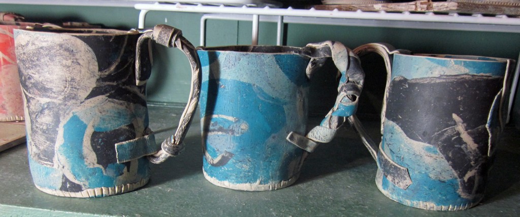 turquoise and black mugs