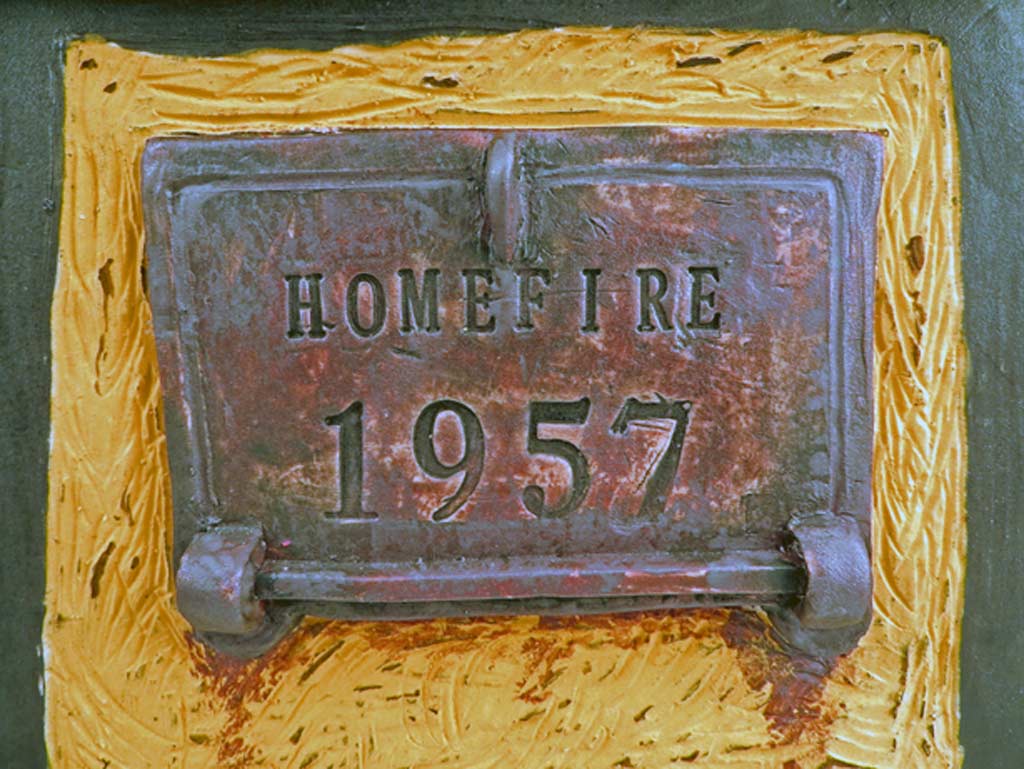 detail of ceramic incinerator door with Homefire 1957 impressed into clay