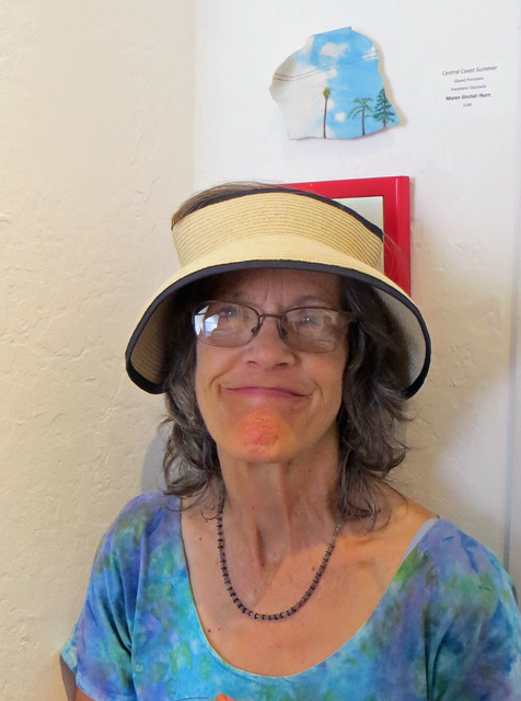 Maren Sinclair Hurn beneath her small ceramic tile entitled Central Coast Summer