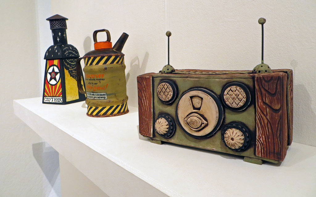 Three ceramic sculptures of incinerator, gas can and communication device