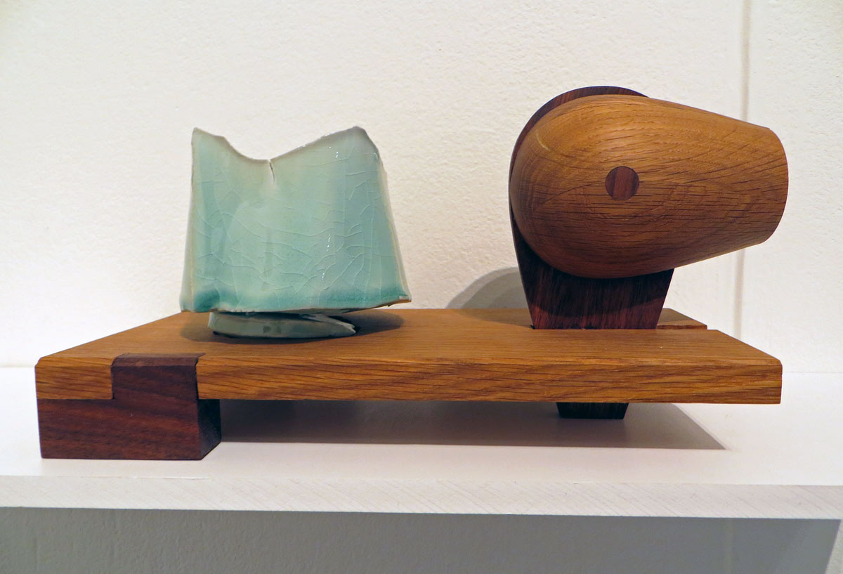 celadon teabowl with sculptural wooden display support