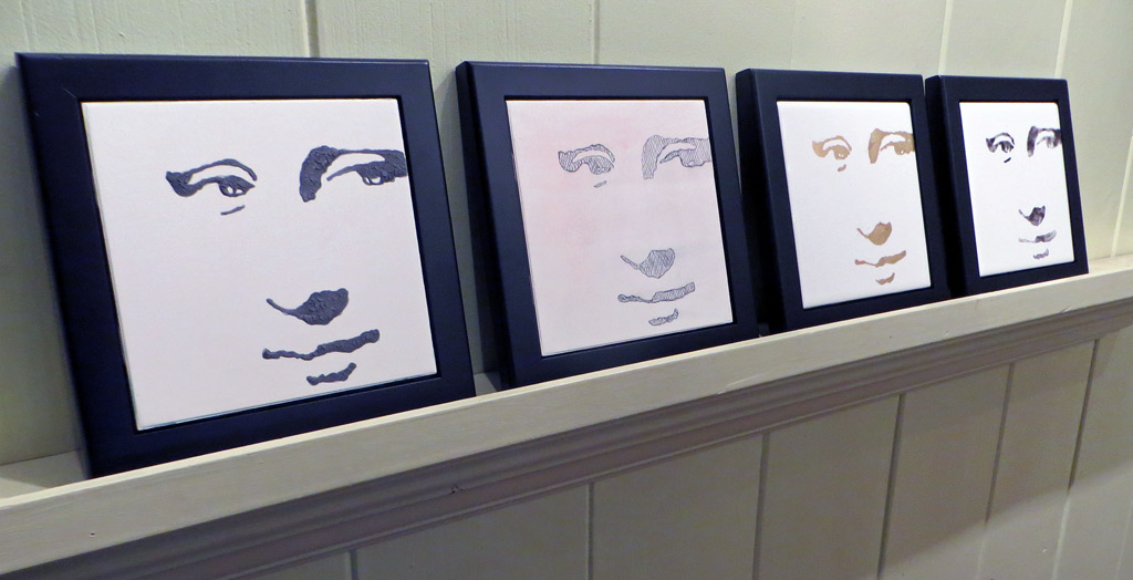 Four framed hi contrast ceramic tiles of Mona Lisa's face.