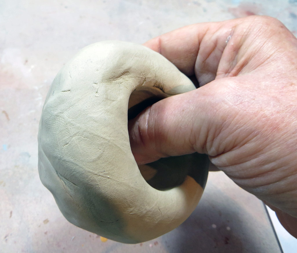 Opening a ball of clay for a pinch pot