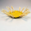 yellow dish with raffia trim side angle